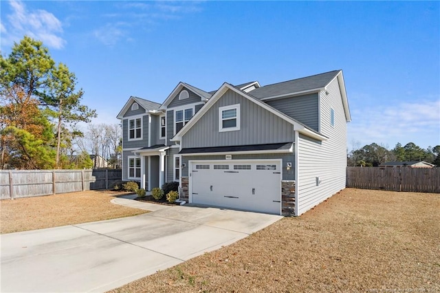 craftsman house featuring a front yard and a garage