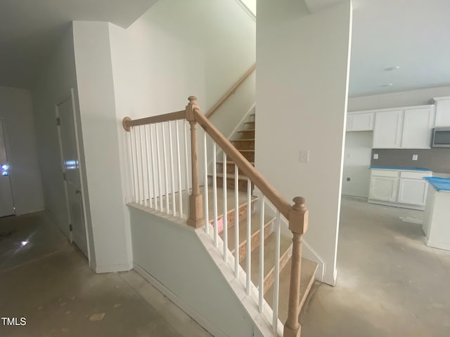 stairway featuring concrete flooring