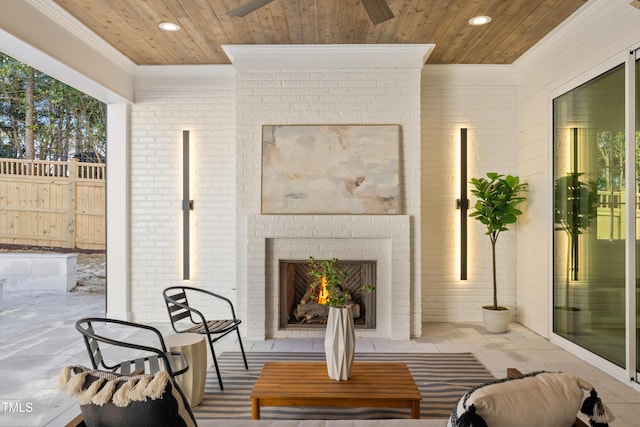 view of patio featuring ceiling fan and an outdoor brick fireplace