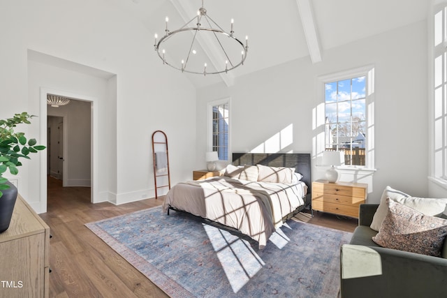 bedroom featuring an inviting chandelier, beam ceiling, hardwood / wood-style flooring, and high vaulted ceiling