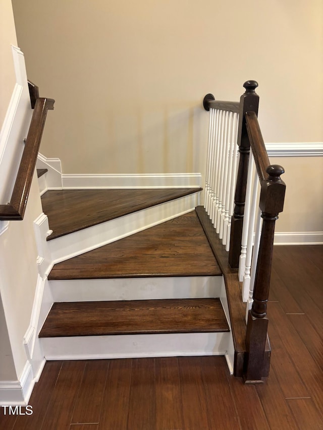 staircase with wood-type flooring