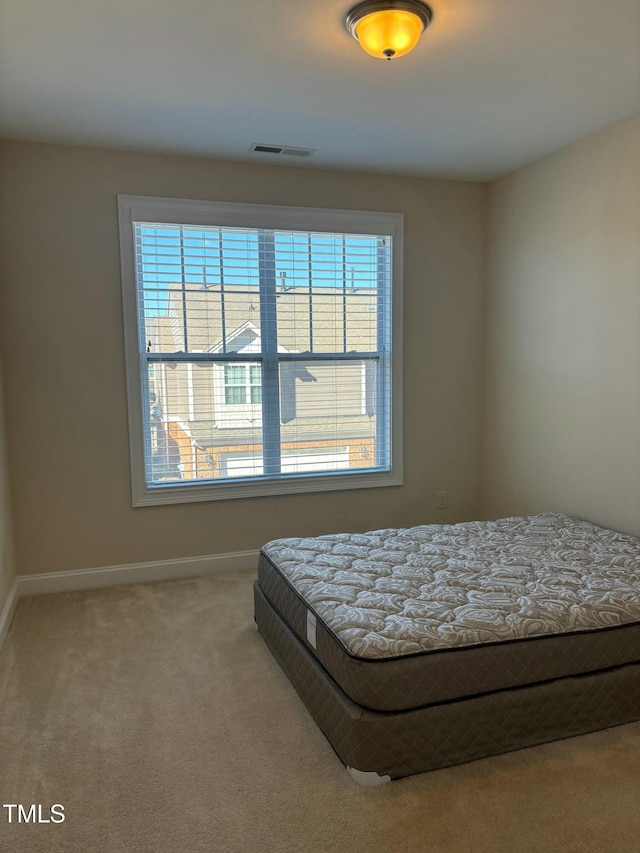 bedroom with multiple windows and carpet flooring