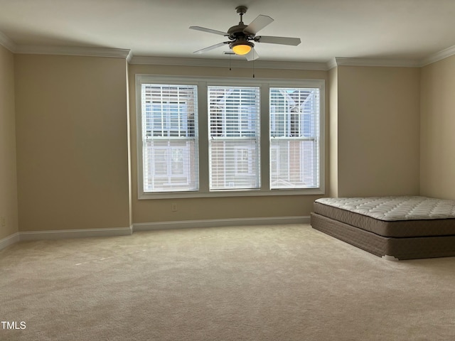 unfurnished bedroom with ceiling fan, ornamental molding, and light carpet