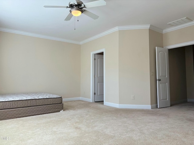 unfurnished bedroom featuring ceiling fan, light colored carpet, and ornamental molding