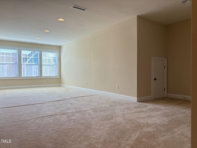 spare room featuring light carpet