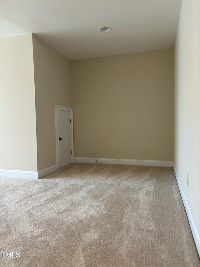 unfurnished room featuring light colored carpet