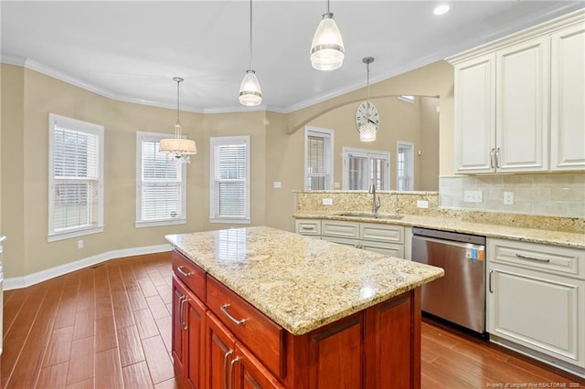 kitchen featuring sink, decorative light fixtures, and stainless steel dishwasher