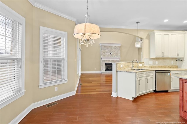 kitchen featuring hanging light fixtures, a healthy amount of sunlight, and stainless steel dishwasher