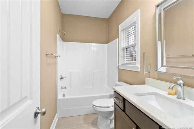 full bathroom with shower / tub combination, vanity, wood-type flooring, and toilet