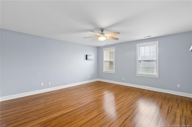 spare room with ceiling fan and hardwood / wood-style floors