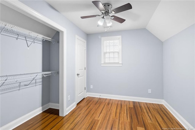 unfurnished bedroom with hardwood / wood-style flooring, lofted ceiling, ceiling fan, and a closet