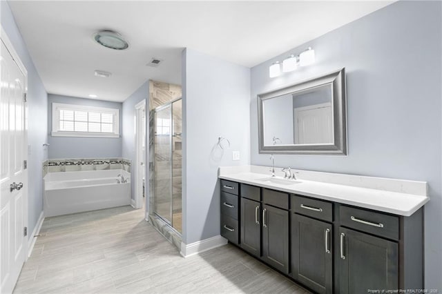 bathroom featuring vanity and plus walk in shower