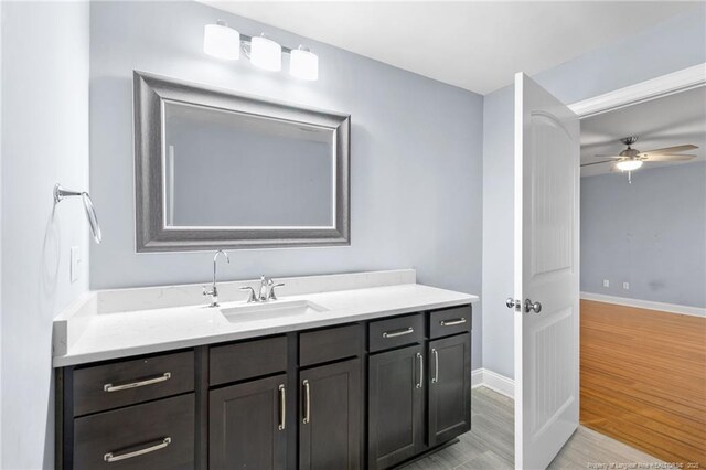 bathroom featuring vanity, hardwood / wood-style flooring, and ceiling fan