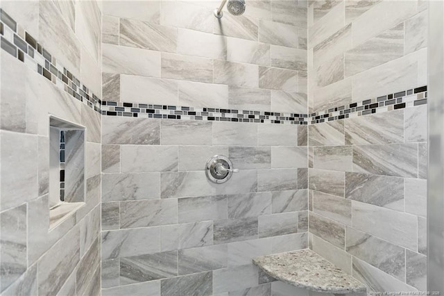 bathroom with tiled shower