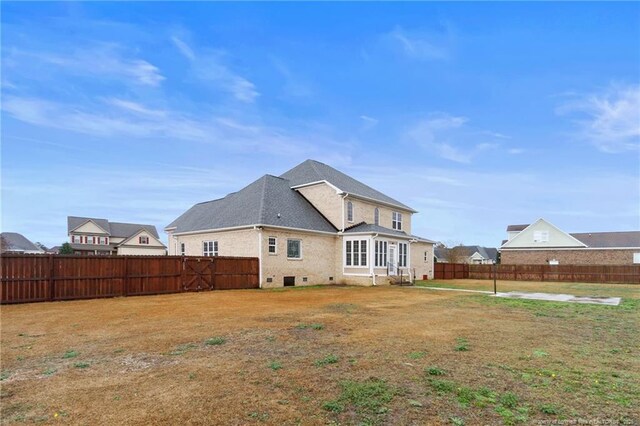 rear view of house with a lawn