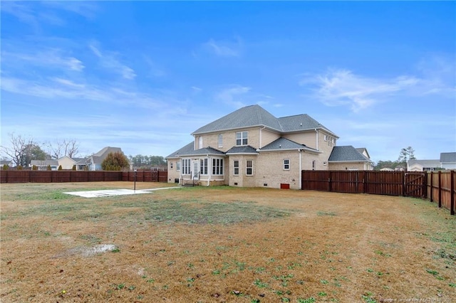 rear view of house featuring a yard and a patio area