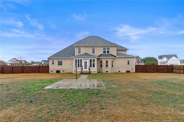 rear view of property featuring a yard and a patio area