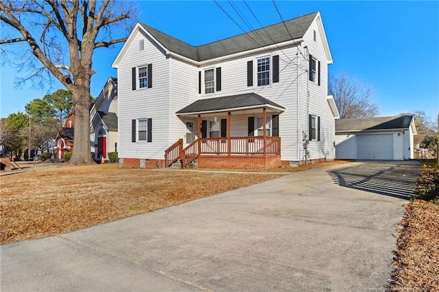 view of property featuring a garage, a front yard, and a porch