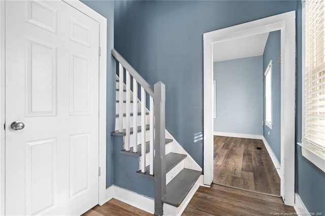 stairs featuring hardwood / wood-style floors