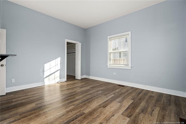 unfurnished bedroom featuring dark hardwood / wood-style flooring