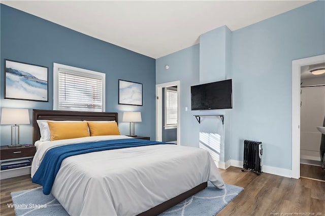 bedroom featuring dark hardwood / wood-style flooring and radiator