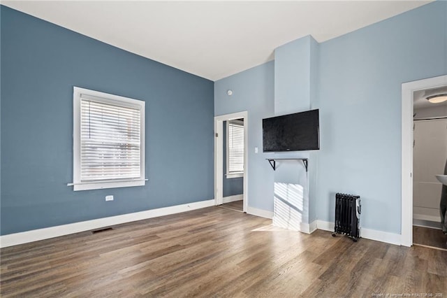 unfurnished living room with dark hardwood / wood-style floors