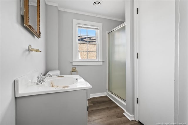 bathroom with walk in shower, vanity, toilet, and hardwood / wood-style floors