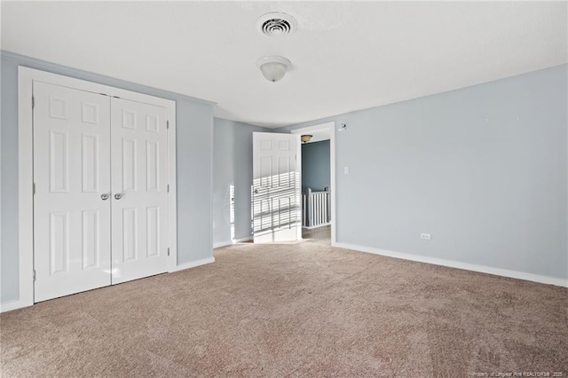 unfurnished bedroom featuring carpet floors and a closet