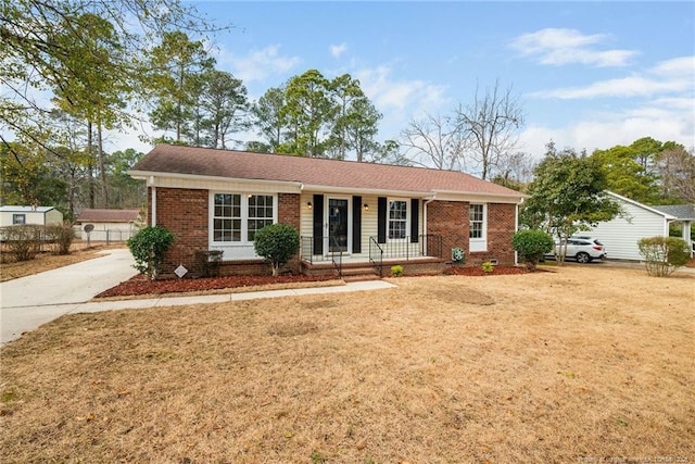 ranch-style house with a front lawn and covered porch