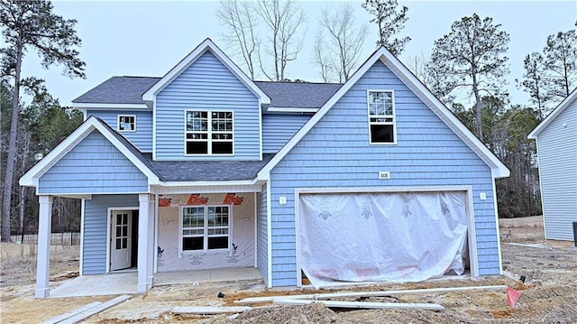 view of front of house with covered porch and a garage