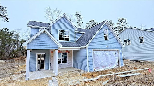 back of property with a garage