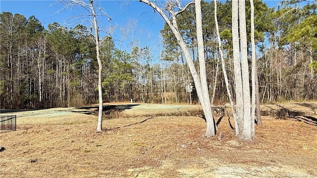 view of landscape featuring a forest view