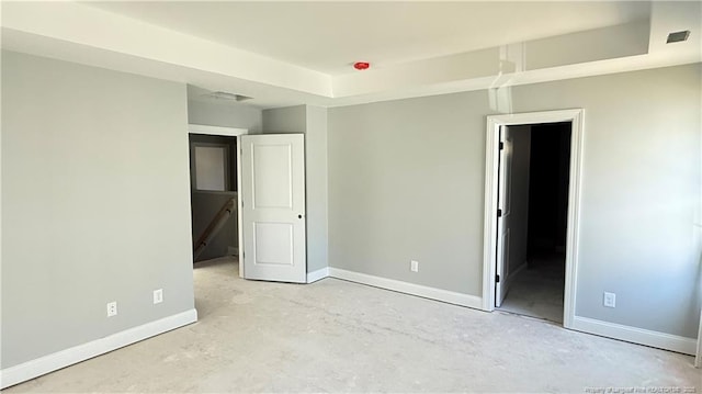 unfurnished bedroom featuring concrete flooring, visible vents, and baseboards