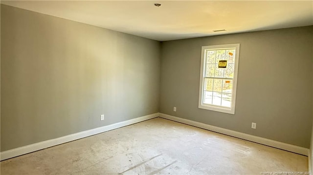 spare room with baseboards