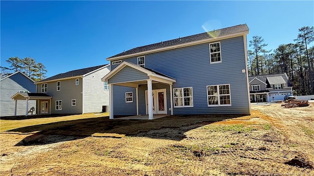 rear view of house with a lawn