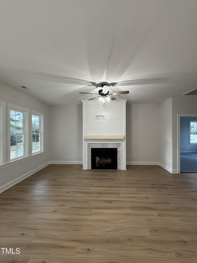 504 Tucker St, Four Oaks, NC 27524 - unfurnished living room featuring visible vents, baseboards, a fireplace, wood finished floors, and a ceiling fan