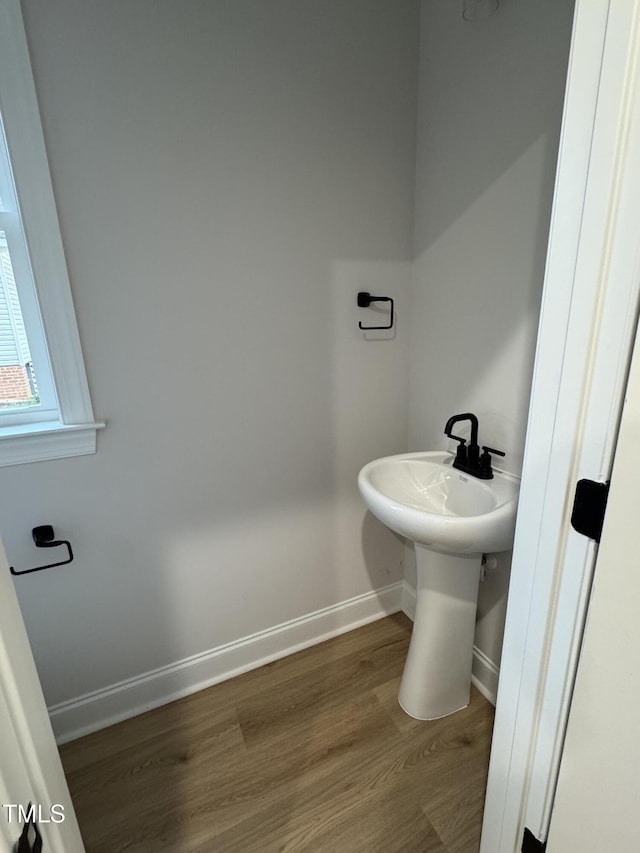 504 Tucker St, Four Oaks, NC 27524 - bathroom with baseboards and wood finished floors