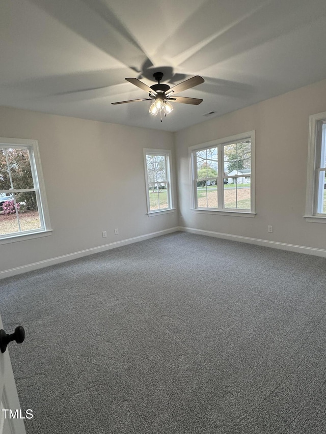 504 Tucker St, Four Oaks, NC 27524 - unfurnished room with dark carpet, a wealth of natural light, baseboards, and ceiling fan