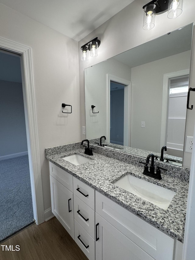504 Tucker St, Four Oaks, NC 27524 - bathroom with double vanity, a sink, baseboards, and wood finished floors