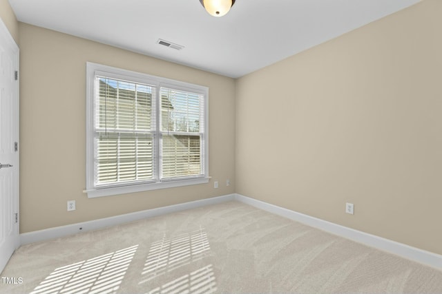 spare room with light colored carpet