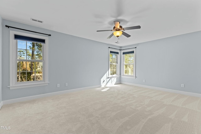 empty room with light colored carpet and ceiling fan