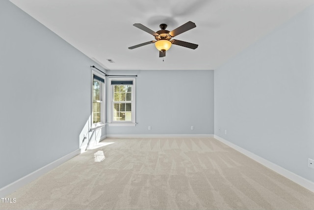 carpeted spare room featuring ceiling fan