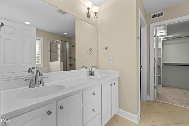 bathroom featuring vanity, tile patterned floors, and a shower with shower door