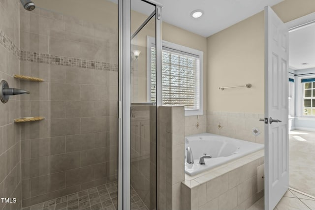 bathroom featuring tile patterned flooring, separate shower and tub, and a wealth of natural light