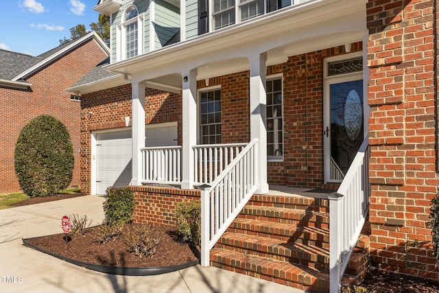 property entrance with a garage and covered porch