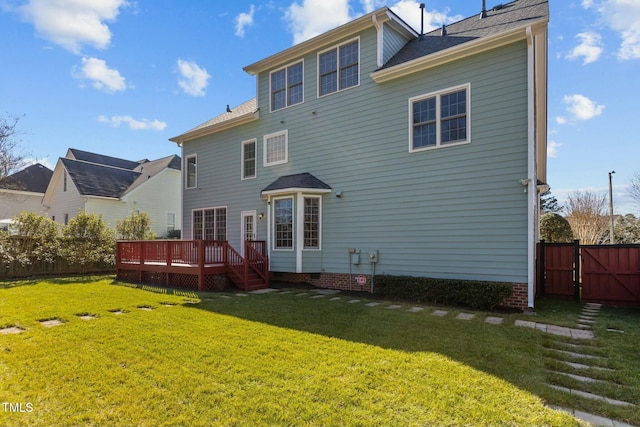 back of house with a deck and a lawn