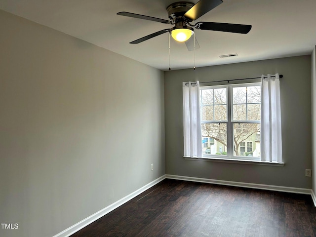 spare room with ceiling fan and dark hardwood / wood-style flooring