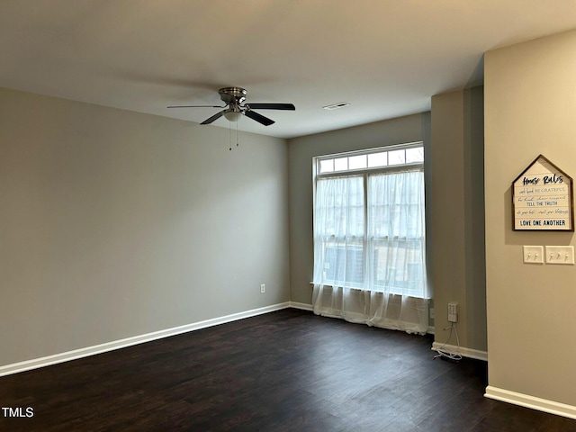 spare room with dark hardwood / wood-style floors and ceiling fan