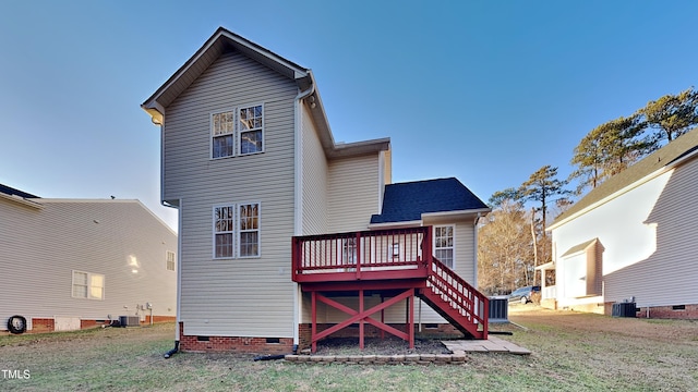 back of property with a deck, a yard, and central air condition unit