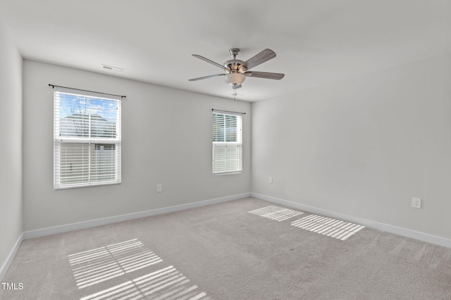 empty room featuring light colored carpet and ceiling fan